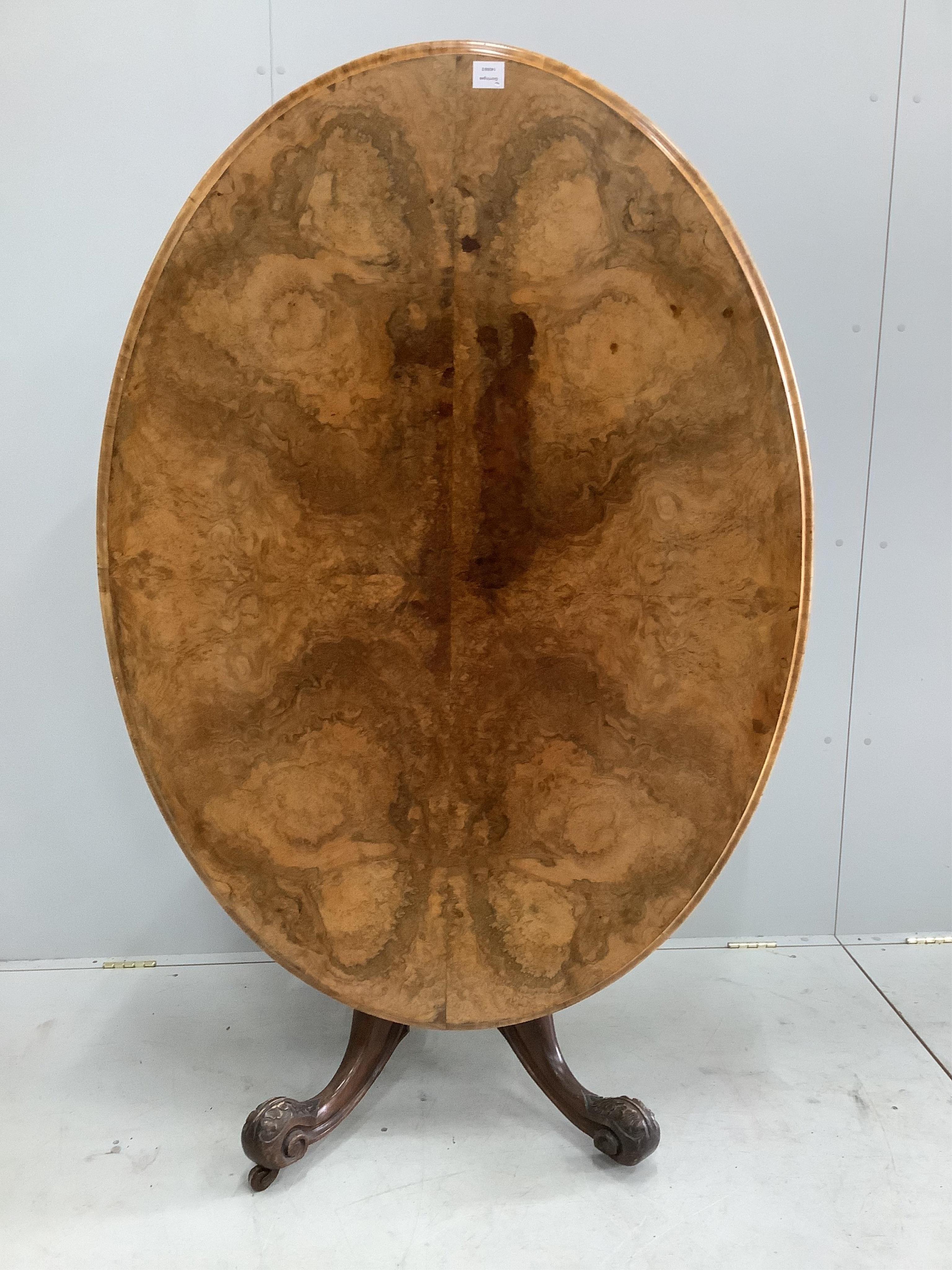 A Victorian figured walnut oval tilt top loo table, width 142cm, depth 104cm, height 72cm together with a set of four late Victorian walnut dining chairs